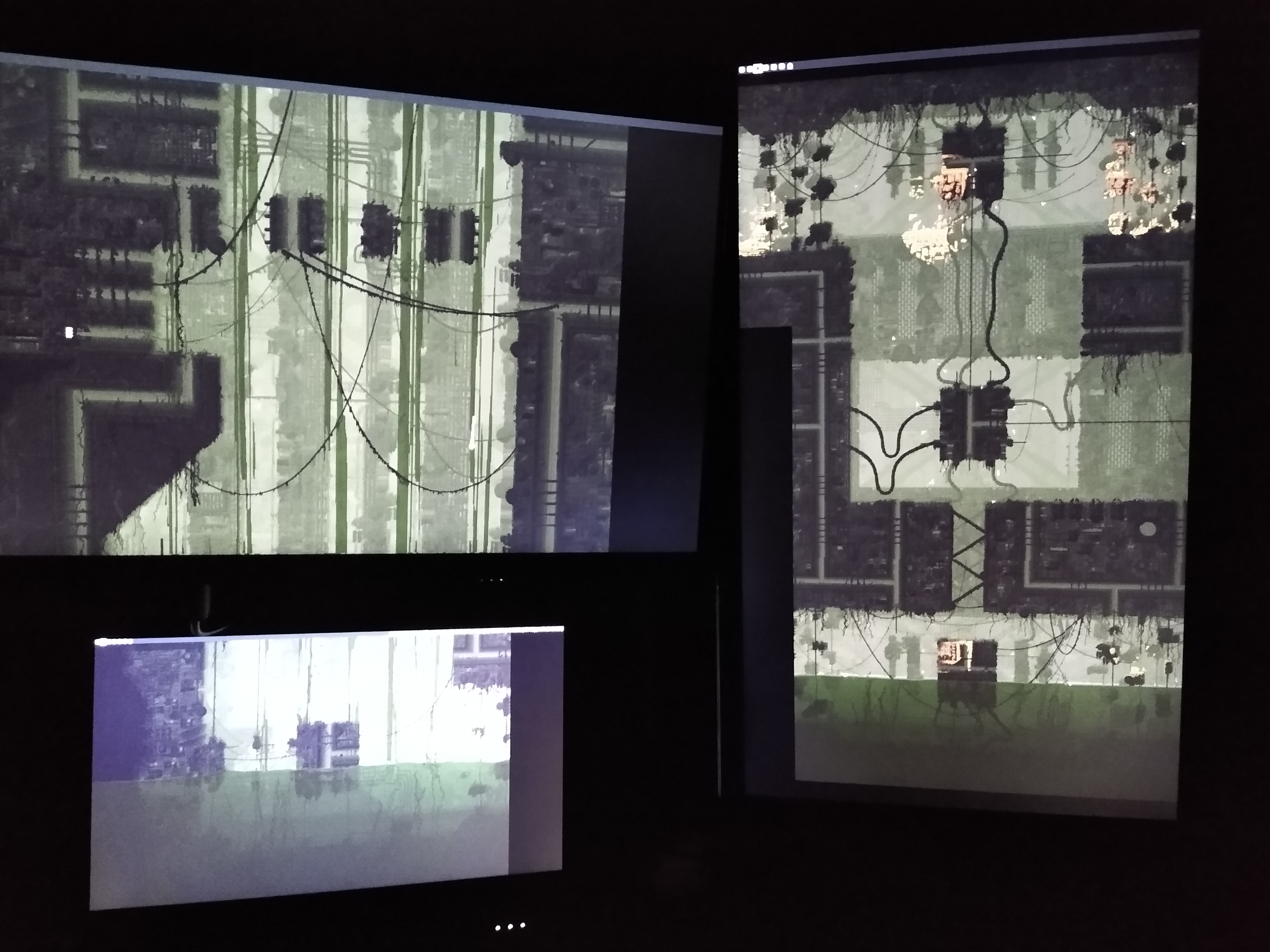 A picture of a computer setup. There are multiple monitors each only displaying a wallpaper, which is stretched across all of the monitors.