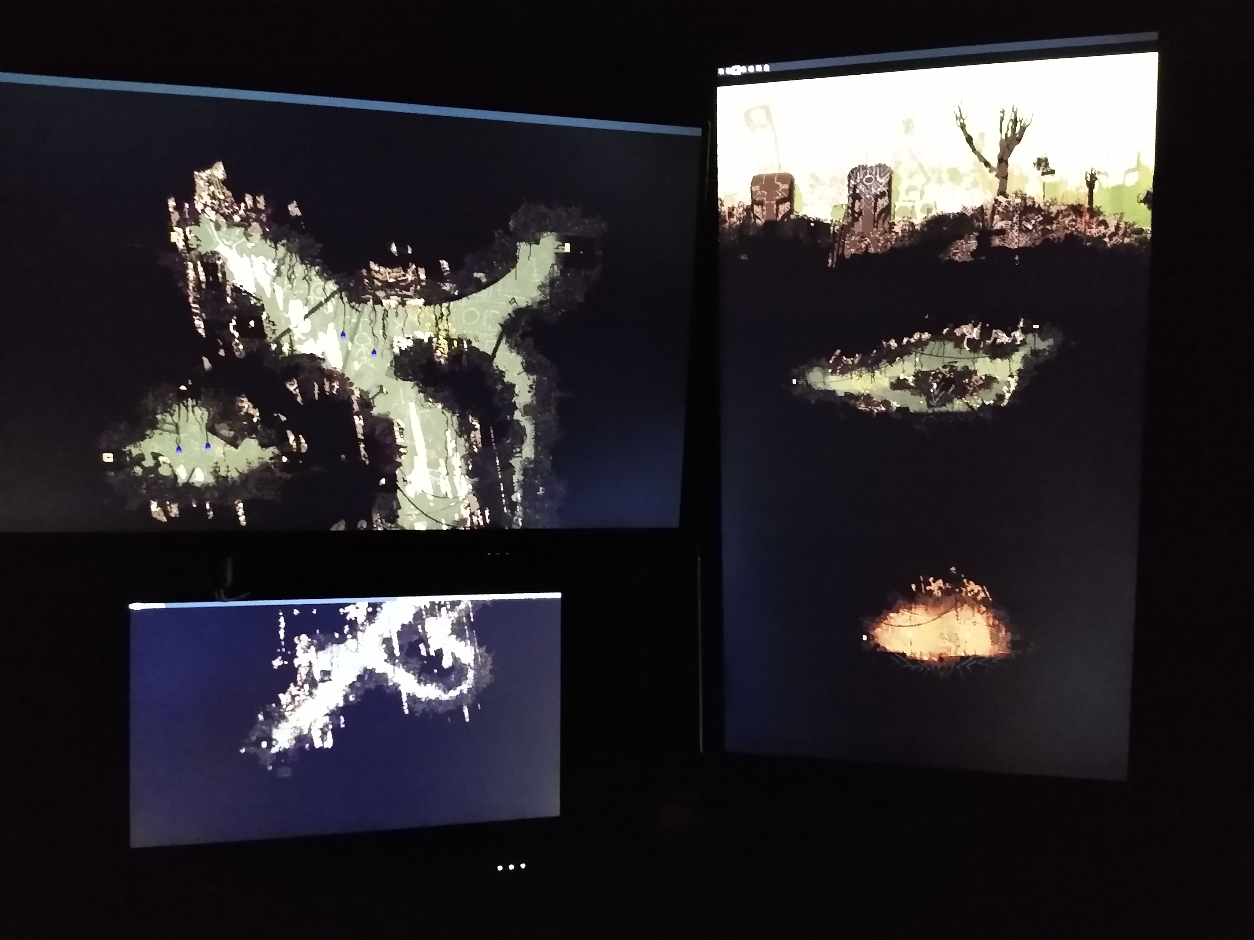 A picture of a computer setup. There are multiple monitors each only displaying a wallpaper, which is stretched across all of the monitors.