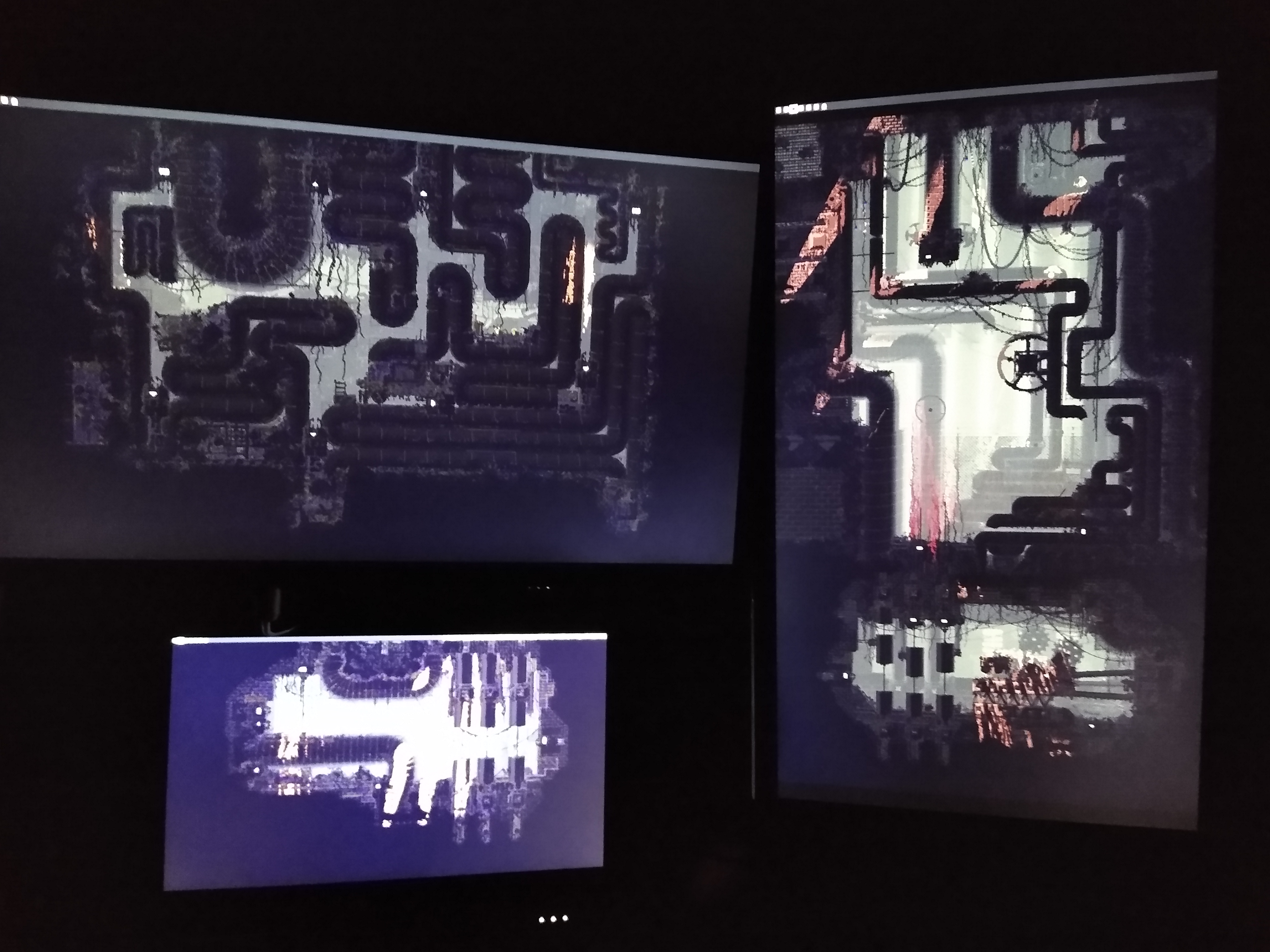 A picture of a computer setup. There are multiple monitors each only displaying a wallpaper, which is stretched across all of the monitors.